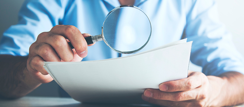 Magnifying Glass Examining Documents