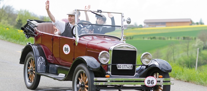 Vintage Car Driving Through Countryside
